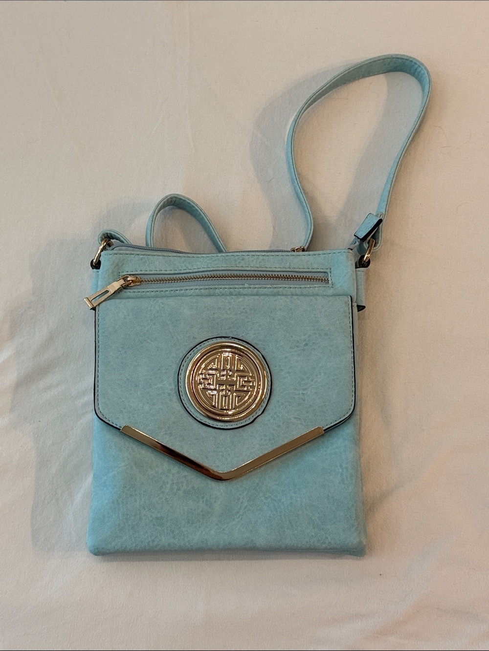 Light Blue Crossbody Bag with Gold Emblem